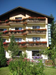 a building with flowers on the balconies of it at Apartment House Seerose in Obertraun