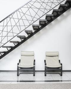 two chairs sitting in a room with a white wall at BOROVOE Country Club in Borovoye