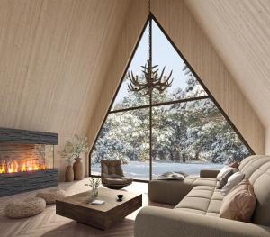 a living room with a large window and a couch at Holmen Husky Lodge in Alta