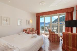 a hotel room with a bed and a balcony at Grand Hotel Mediterranee in Alassio