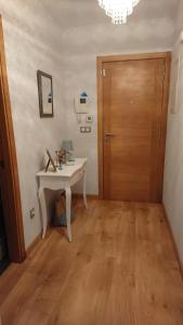 a room with a table and a wooden door at PONTECESO, MAR Y FER in Ponteceso