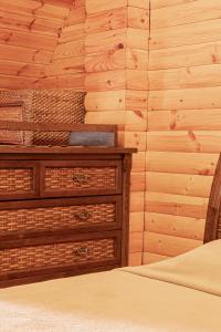 a bedroom with a bed and a wooden wall at BOROVOE Country Club in Borovoye