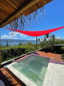 a swimming pool on the deck of a house at Villa Villagio di Mare in Ilhabela