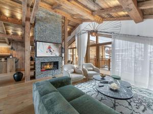 a living room with a couch and a fireplace at Chalet Courchevel, 6 pièces, 10 personnes - FR-1-568-27 in Courchevel