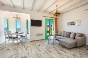 a living room with a couch and a table at La Scala Luxury Villa Μikis Theodorakis with jacuzzi in Karpathos