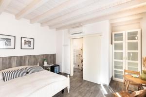 マリーナ・ディ・カッラーラにあるB&B Residenza Marinaの白いベッドルーム(ベッド1台、テーブル付)