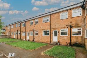 an empty brick building with a white door at Modern 2BR Apt Contractor stay in Hinckley