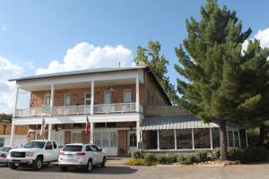 a building with cars parked in front of it at The Hotel Limpia in Fort Davis