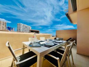 a dining table on a balcony with a view of the city at El Horno in Adeje