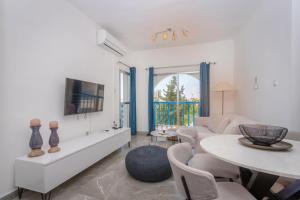 a living room with a couch and a table at White Arches Apt #2 by TrulyCyprus in Limassol