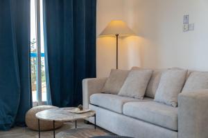 a living room with a couch and a table at White Arches Apt #2 by TrulyCyprus in Limassol