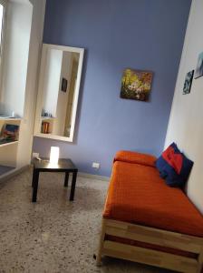 a room with a bed and a table with a mirror at CASA SIRENETTA-Little Mermaid House in Lentini