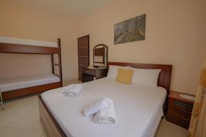 a bedroom with a bed with two towels on it at Villa M Cako in Ksamil