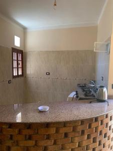 a kitchen with a brick counter top and a stove at Villa Elhag Nile View in Luxor