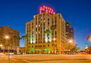 a building with a neon sign on top of it at Hotel De Anza, a Destination by Hyatt Hotel in San Jose