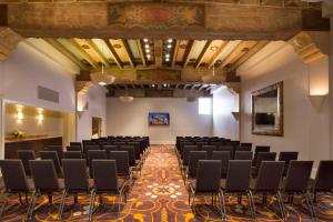 a room with rows of chairs and a stage at Hotel De Anza in San Jose