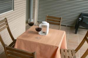 stół z dwoma kieliszkami czerwonego wina w obiekcie Apartamento en centro de Archena w Murcji
