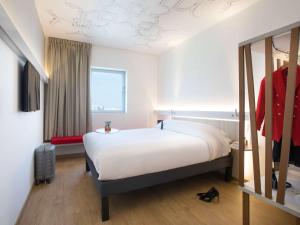 a bedroom with a large bed and a window at Ibis Abdelmoumen Casa Centre in Casablanca