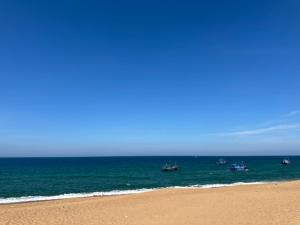 a group of boats in the water on a beach at Homestay Beach View 2 in Phú Hiệp