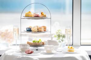 a table with a plate of pastries on a shelf at L’Horizon Beach Hotel & Spa in St. Brelade