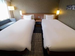 Postel nebo postele na pokoji v ubytování ibis Styles Tokyo Ginza