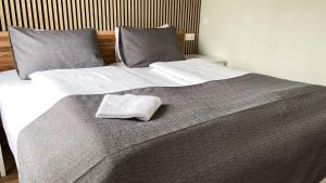 un letto con due cuscini e un asciugamano sopra di Skipalaekur Guesthouse a Egilsstadir