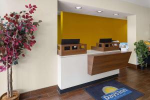 a room with a counter with two birds on the wall at Days Inn by Wyndham Pottstown in Pottstown