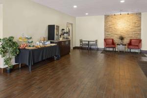 a large room with a table and chairs and a kitchen at Days Inn by Wyndham Pottstown in Pottstown