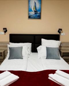 a large bed with white sheets and pillows at Hotel Casablanca in Goražde