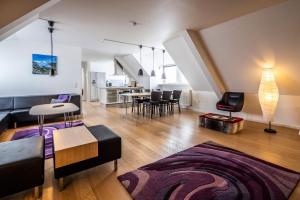 a living room with a couch and a table at HOTEL SØMA Ilulissat in Ilulissat