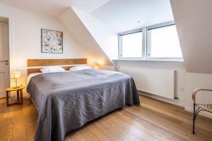 a bedroom with a bed and a large window at HOTEL SØMA Ilulissat in Ilulissat