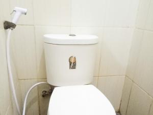 een badkamer met een toilet met een sticker erop bij RedDoorz near RS Labuang Baji in Balangberu