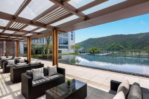 an outdoor patio with couches and a swimming pool at Wyndham Taizhou West in Taizhou