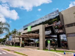 a building with a green sign on the side of it at ibis Styles Goiânia Shopping Estação in Goiânia