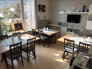 uma sala de jantar com mesas e cadeiras de madeira em Haus Kolbnitz em Unterkolbnitz