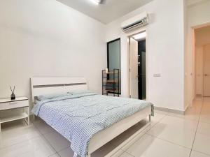 a white bedroom with a bed and a chair at Lovely Eco Home in Gelang Patah +11 photos