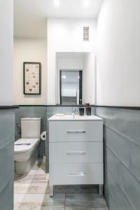 Un baño con un lavabo blanco y un inodoro. en Home2Book Cozy Escape near Las Canteras Beach, en Las Palmas de Gran Canaria 26 fotos más