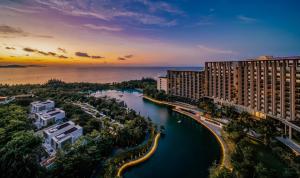 an aerial view of a resort with a lake at The Sanya EDITION in Sanya