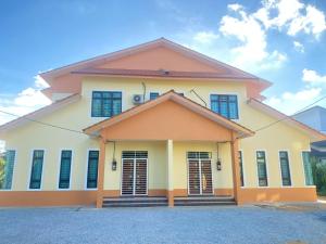 a house with blue shuttered windows on it at MJ Homestay Kota Bharu in Kota Bharu
