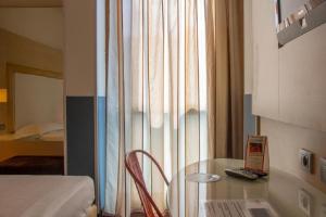 A bed or beds in a room at Smy Bologna Centrale