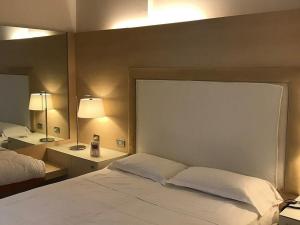 A bed or beds in a room at Smy Bologna Centrale