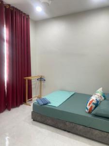 Postel nebo postele na pokoji v ubytování MJ Homestay Kota Bharu