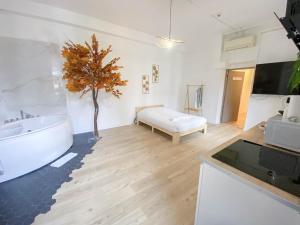 a bathroom with a white tub and a tree in it at Hotel Le Céleste in Nice +291 photos