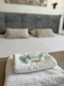 a white towel with two toothbrushes on a bed at Vitas Apartments in Zaton