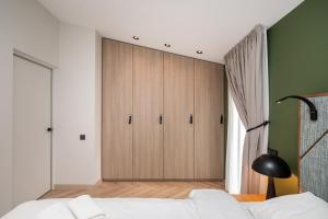 a bedroom with a large wooden cabinet in the corner at SeaView, 5*Appartment,RoofTopTerrace, WalkToBeach in Šventoji
