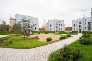 a brick walkway in front of two large buildings at SeaView, 5*Appartment,RoofTopTerrace, WalkToBeach in Šventoji