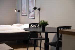 a table and chairs in a room with a bed at Bunks at Rode in Oslo