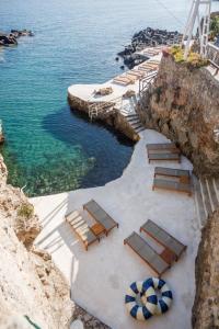 an aerial view of a beach with chairs and the water at Pagoda Lifestyle Hotel in Ischia