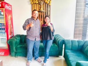 a man and a woman standing in front of a couch at Avista Hotel in Amritsar