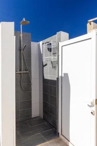 a bathroom with a shower in the side of a building at Chalet OLIVA NOVA in Oliva